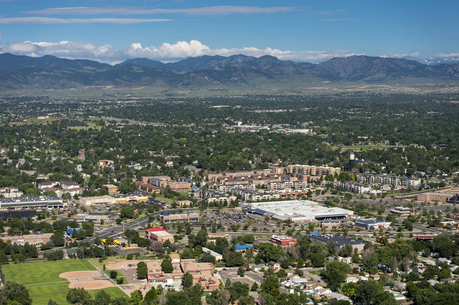 Aerial view of a suburb spreading toward the foothills of the Rocky Mountains